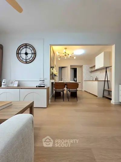 Spacious open-plan living and dining area with modern kitchen design and stylish decor.
