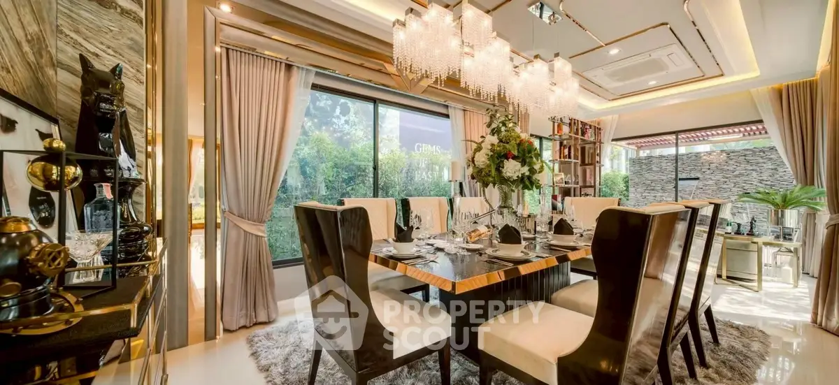 Luxurious dining room with elegant chandelier and large windows overlooking garden