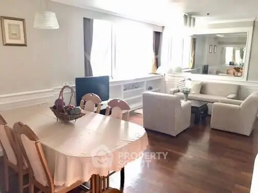 Spacious living and dining area with elegant decor and natural light