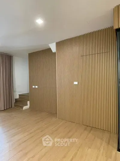 Modern interior with wooden panel walls and staircase, ideal for stylish living space
