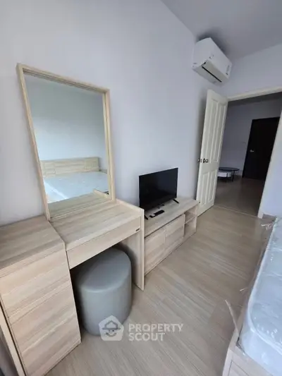 Modern bedroom with sleek furniture and air conditioning, perfect for comfort and style.