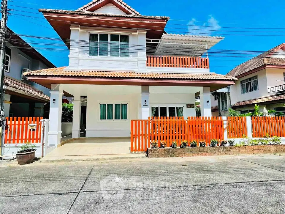 Charming two-story house with orange accents and spacious balcony in a serene neighborhood.