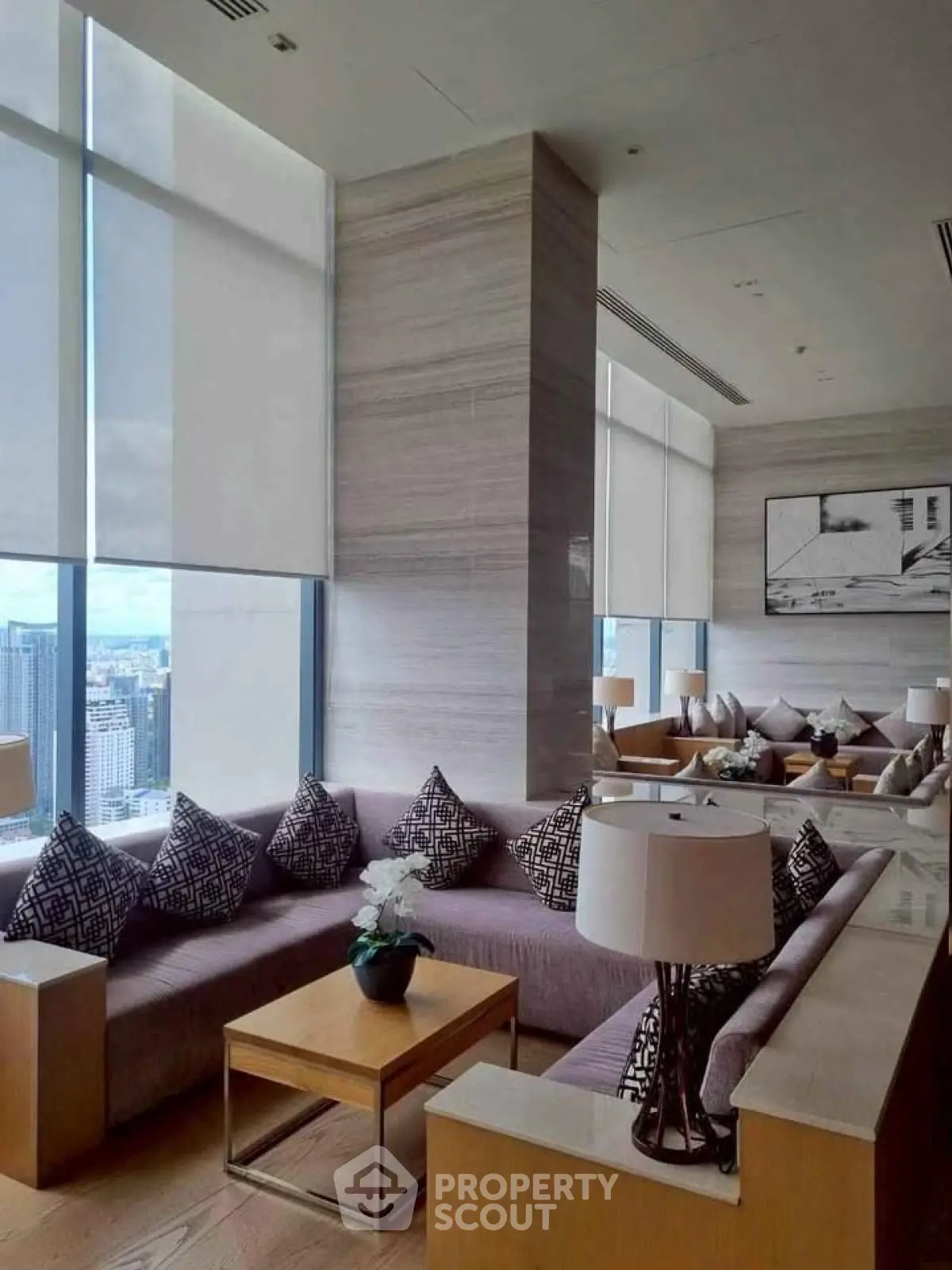 Luxurious living room with panoramic city views and elegant modern decor.