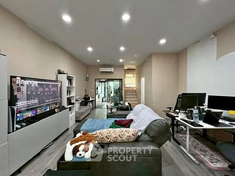 Spacious living room with modern decor and entertainment setup
