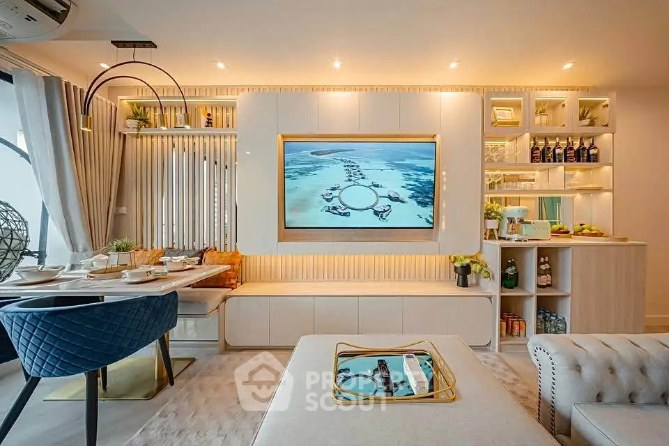 Luxurious modern living room with elegant decor and built-in entertainment center.