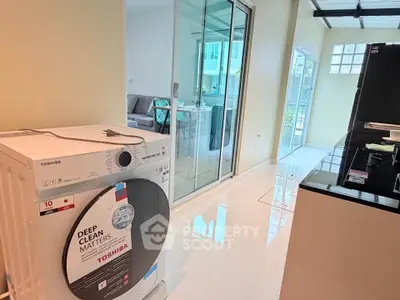 Modern interior with washing machine and sleek kitchen design