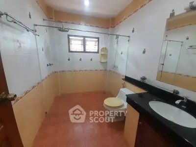 Spacious bathroom with modern fixtures and large mirror