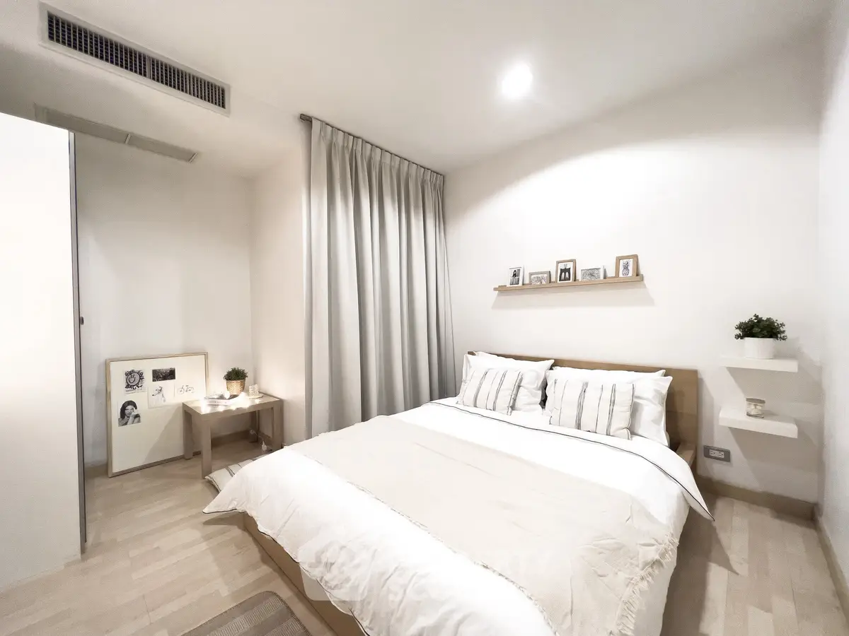 Modern minimalist bedroom with cozy decor and soft lighting