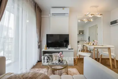 Modern living room with stylish decor and open layout, featuring a cozy dining area and natural light.