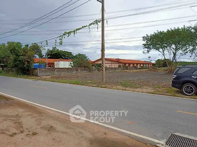 Spacious land plot with potential for development near a quiet road.