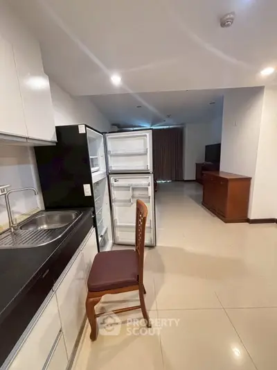 Spacious kitchen with open layout and modern appliances in a contemporary apartment.
