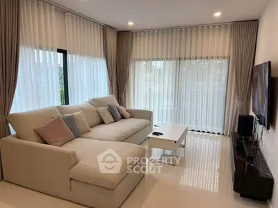 Spacious living room with modern decor and large windows for natural light.