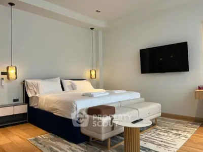 Luxurious modern bedroom with elegant decor and flat-screen TV