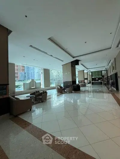 Spacious modern building lobby with elegant seating and large windows