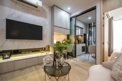 Modern living room with open kitchen, stylish decor, and cozy ambiance in a contemporary apartment.