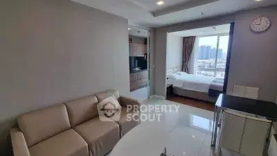 Modern apartment interior with cozy living room and bedroom, featuring city view.