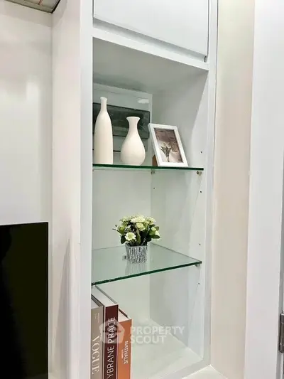 Stylish built-in shelving with decorative vases and books in modern interior design.