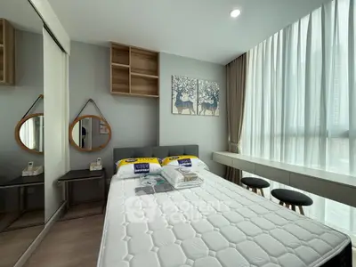 Modern bedroom with stylish decor and large window for natural light