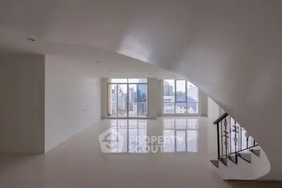 Spacious modern living room with city view and elegant staircase