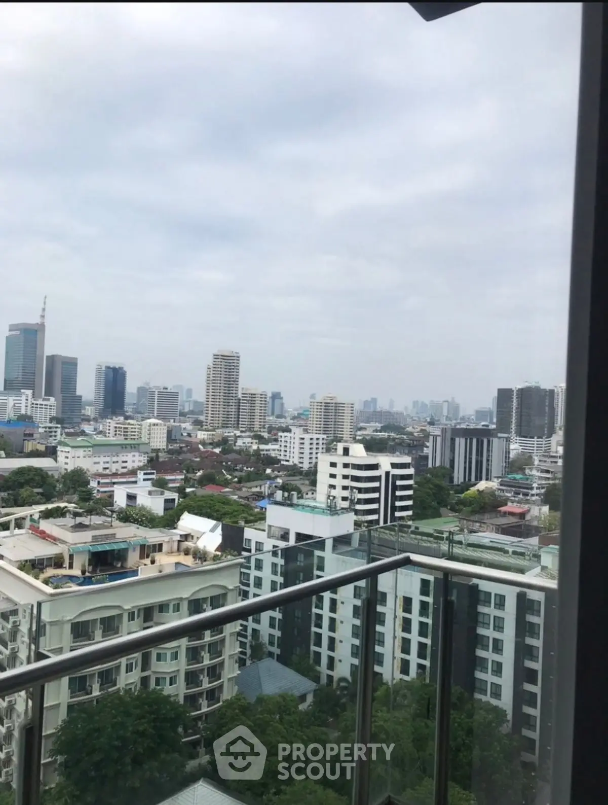 Stunning cityscape view from a high-rise balcony in urban setting.