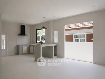 Spacious modern kitchen with open layout and large windows for natural light.