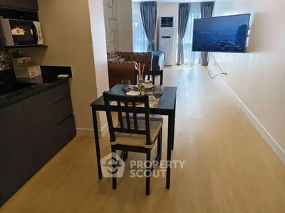 Modern open-plan living area with sleek kitchen and cozy dining space