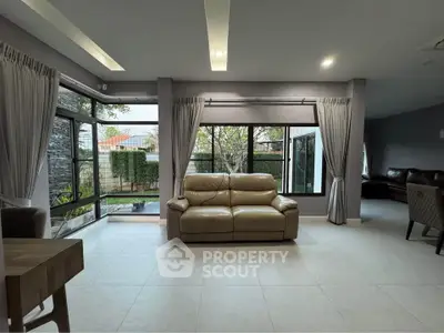 Spacious modern living room with large windows and elegant decor
