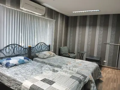 Cozy bedroom with twin beds and modern decor in stylish apartment