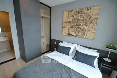 Modern bedroom with stylish decor and open closet, featuring a map artwork above the bed.