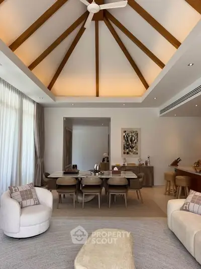 Luxurious living room with vaulted ceiling and elegant dining area