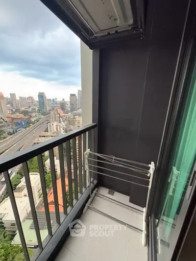Urban balcony with city view and drying rack, perfect for modern living.