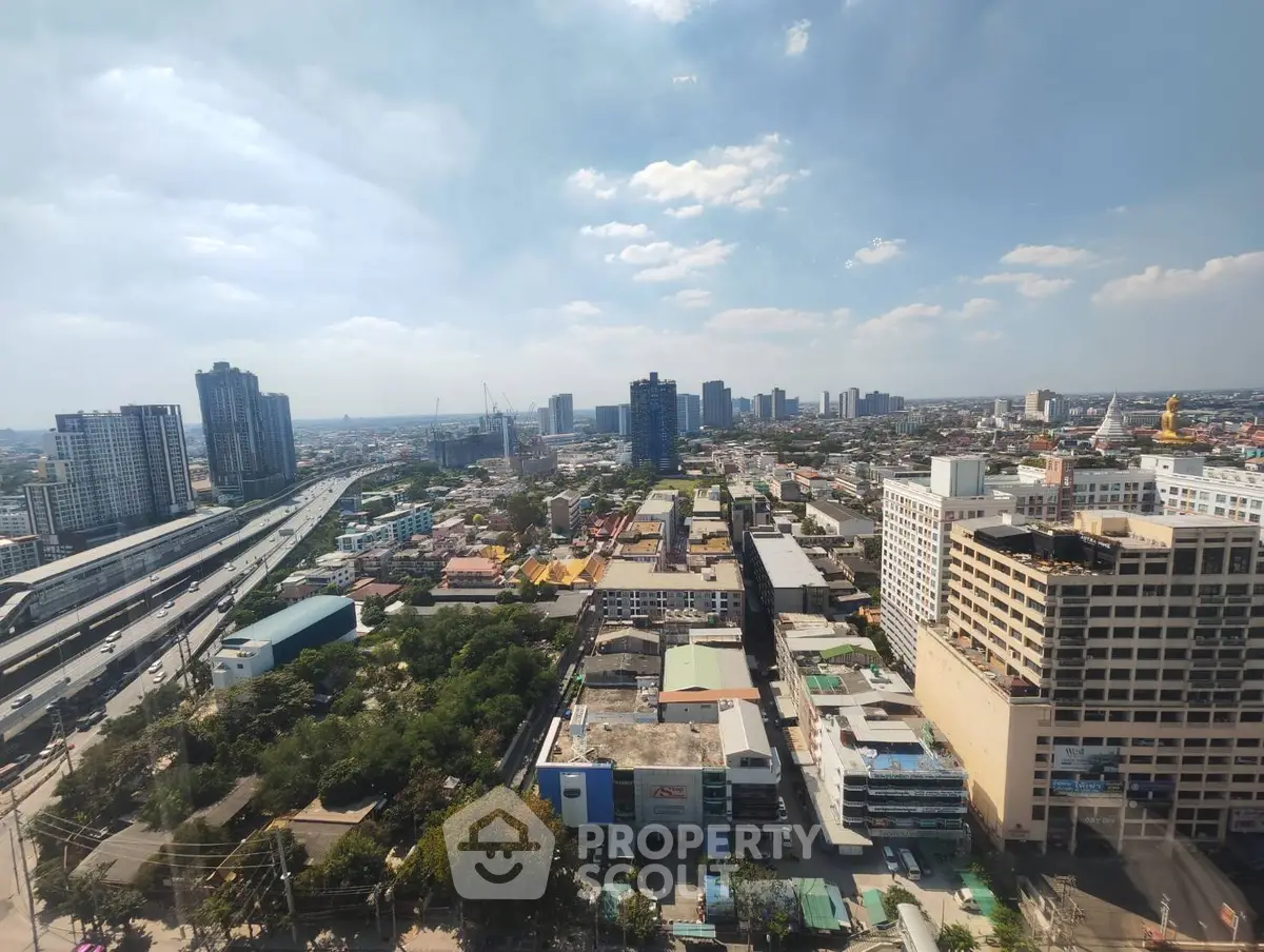 Stunning cityscape view from high-rise building showcasing urban skyline and highway.