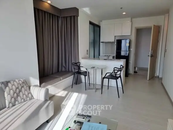 Modern apartment interior with open kitchen and cozy living area