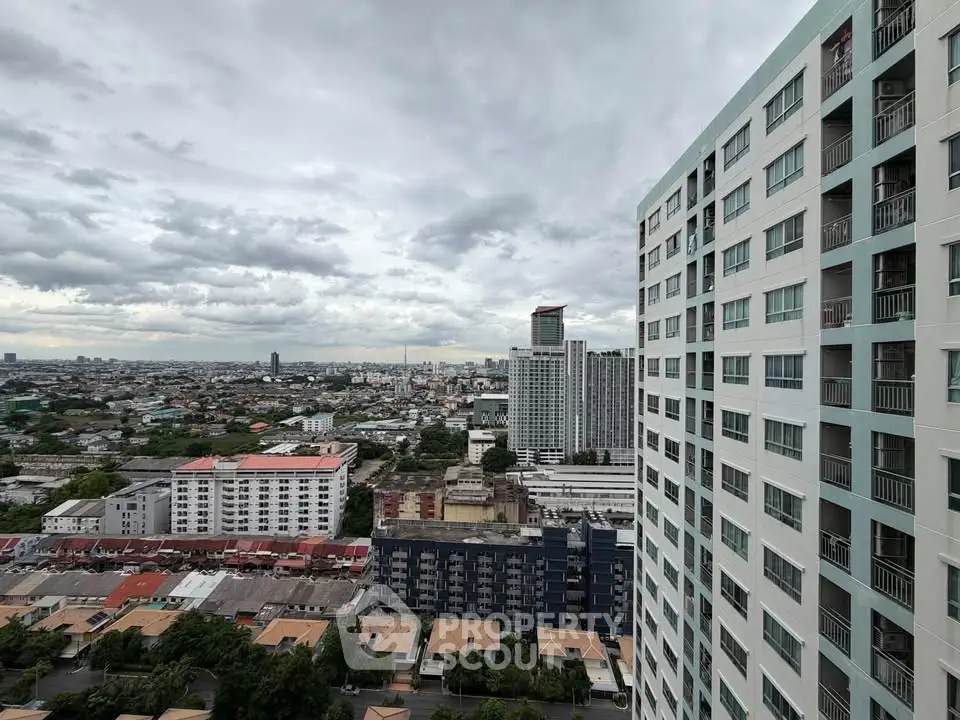 Stunning cityscape view from high-rise building showcasing urban skyline and residential architecture.