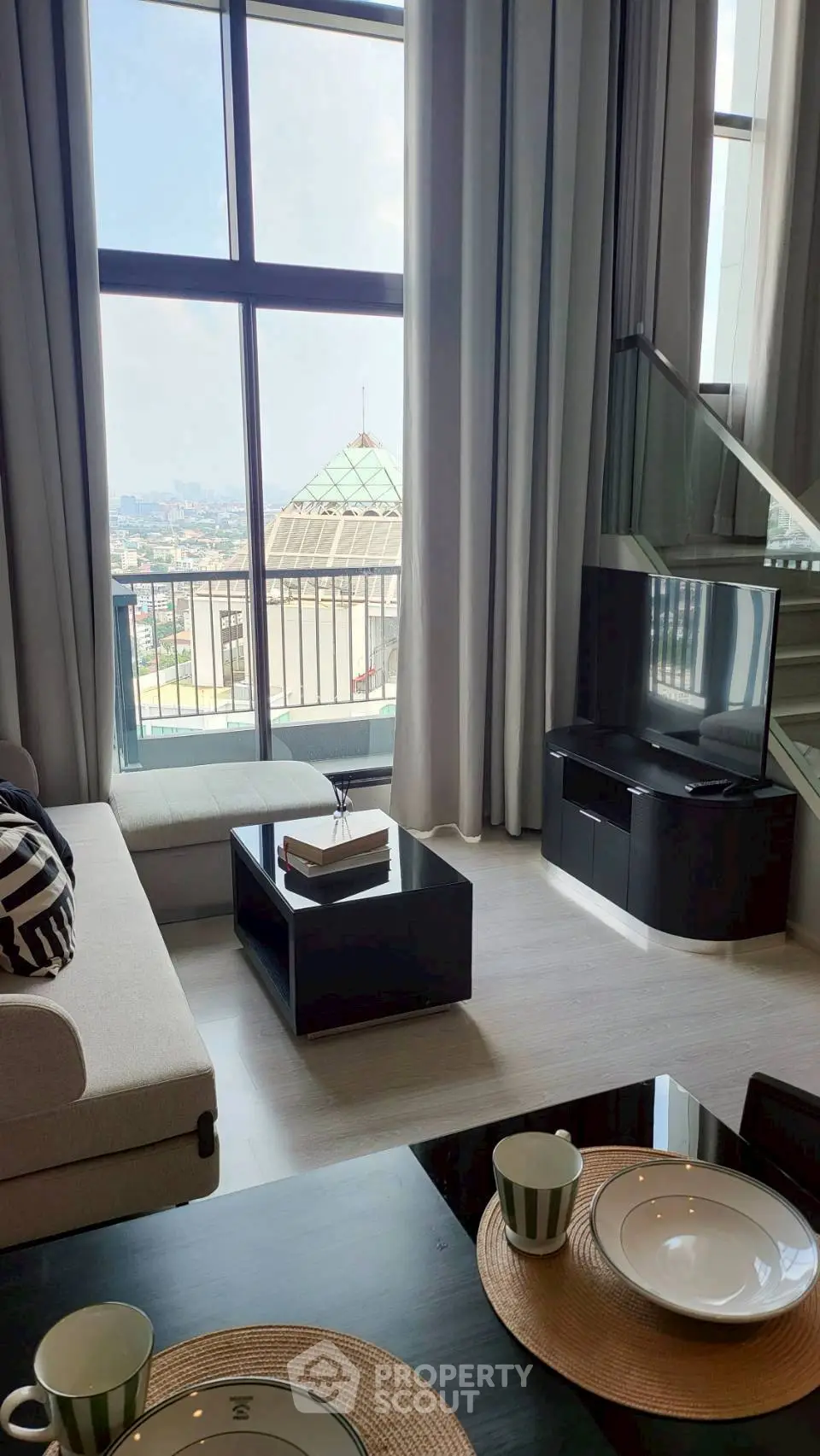 Luxurious living room with floor-to-ceiling windows and stunning city view