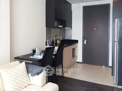 Modern compact kitchen with dining area in a cozy apartment