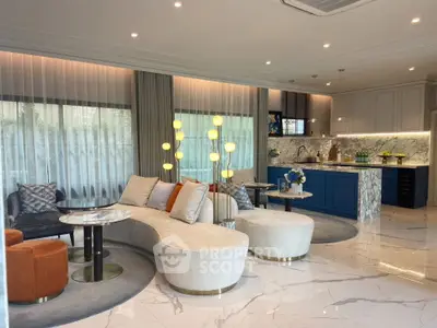 Luxurious open-plan living room with elegant marble flooring and modern kitchen design.