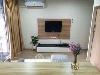 Modern living room with wall-mounted TV and stylish decor