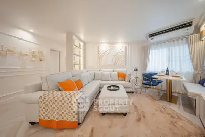 Luxurious living room with elegant decor and plush seating in a modern apartment.