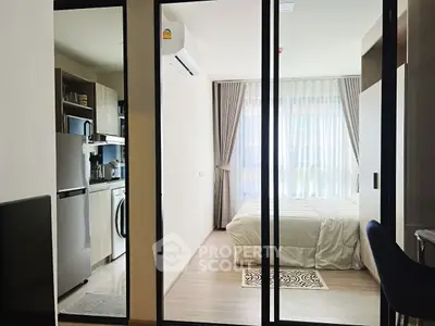 Modern studio apartment with sleek kitchen and cozy bedroom, perfect for urban living.
