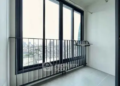 Modern balcony with city view and sleek railing in high-rise apartment.