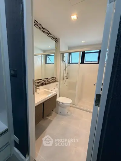 Modern bathroom with sleek design and large mirror in a contemporary home.