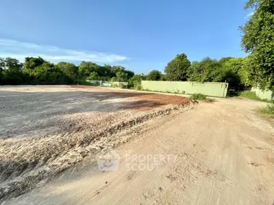 Expansive land plot with lush greenery, perfect for development opportunities.