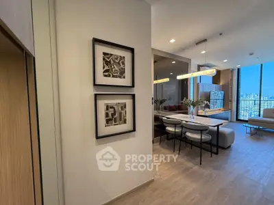 Modern open-layout living room with stylish decor and city view, perfect for urban living.