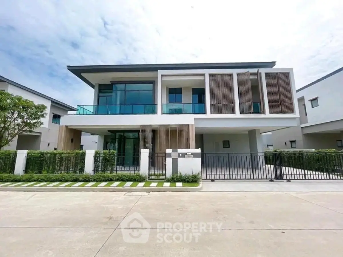 Modern luxury house with large windows and stylish facade in a serene neighborhood.