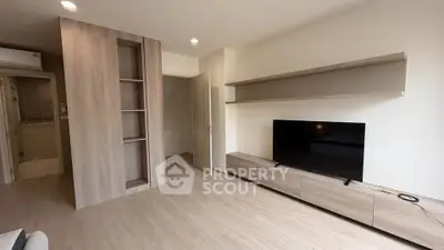 Modern living room with sleek wooden furniture and built-in shelves, perfect for contemporary living.