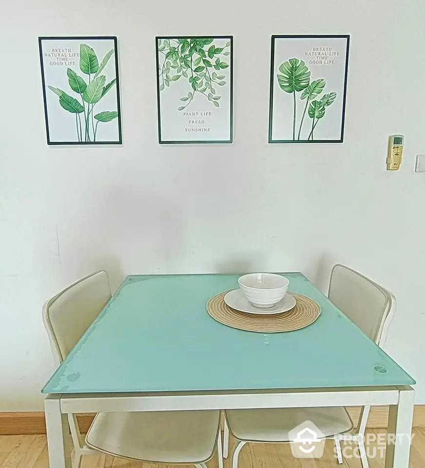 Charming dining area with modern glass table and stylish wall art