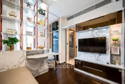 Modern living room with marble accents and built-in TV unit, featuring stylish shelving and cozy seating.