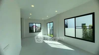 Spacious and bright living room with large windows and modern design