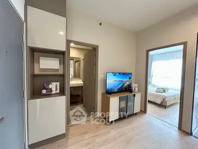 Modern apartment interior with open living space and bedroom view